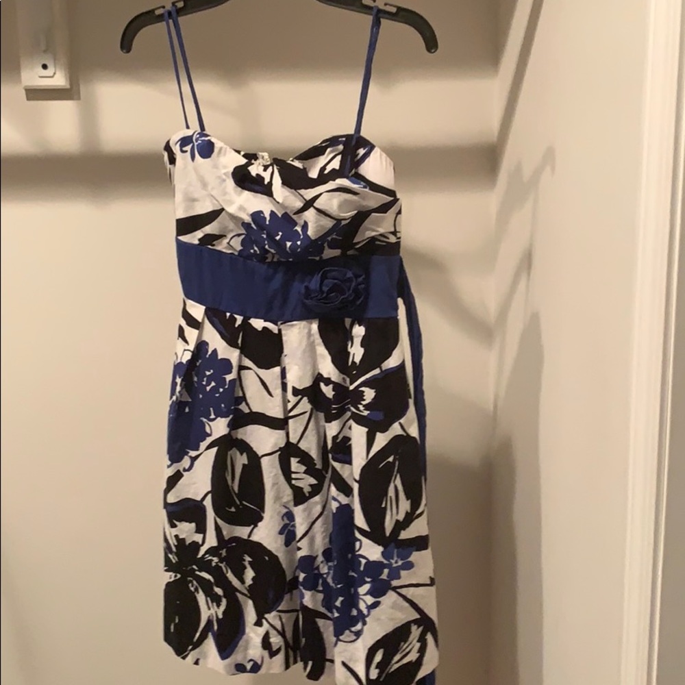 white dress with blue and black floral design